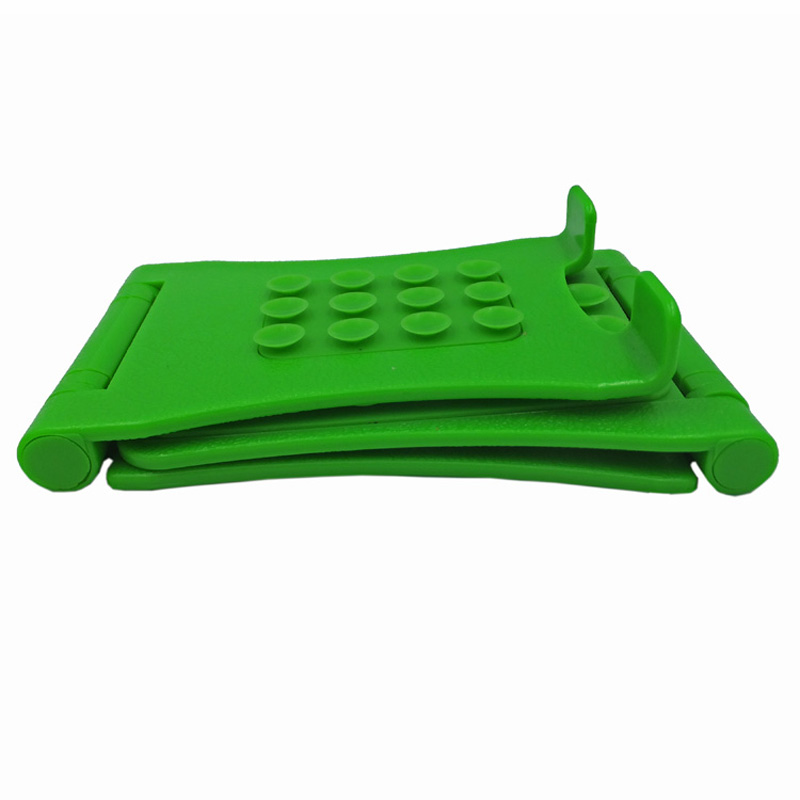 Groene verstelbare opvouwbare siliconen telefoonhouder